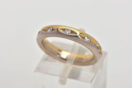 A FULL DIAMOND ETERNITY RING, the band designed with half yellow and half white colour metal, set