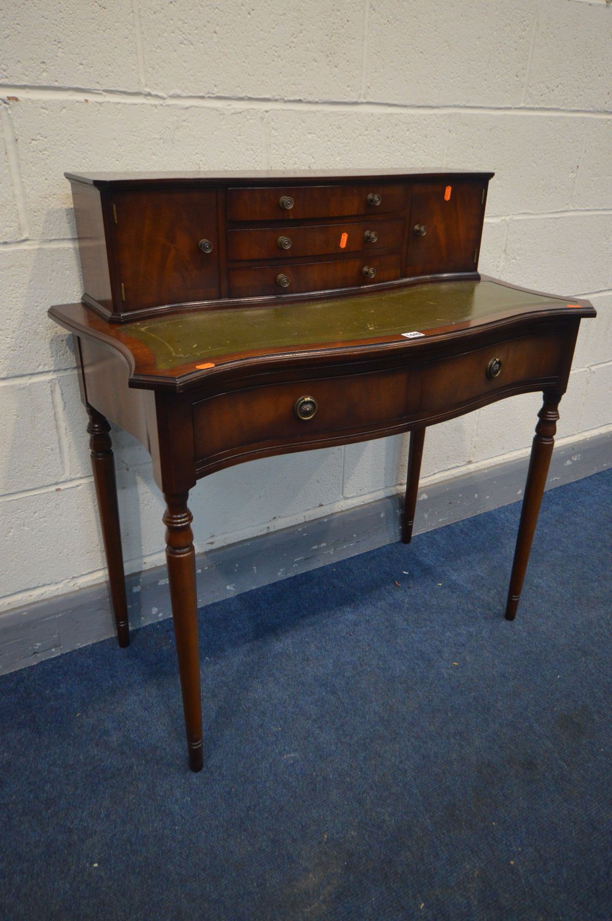 A REPRODUCTION MAHOGANY BONHEUR DU JOUR, with an arrangement of drawers, on turned legs, width