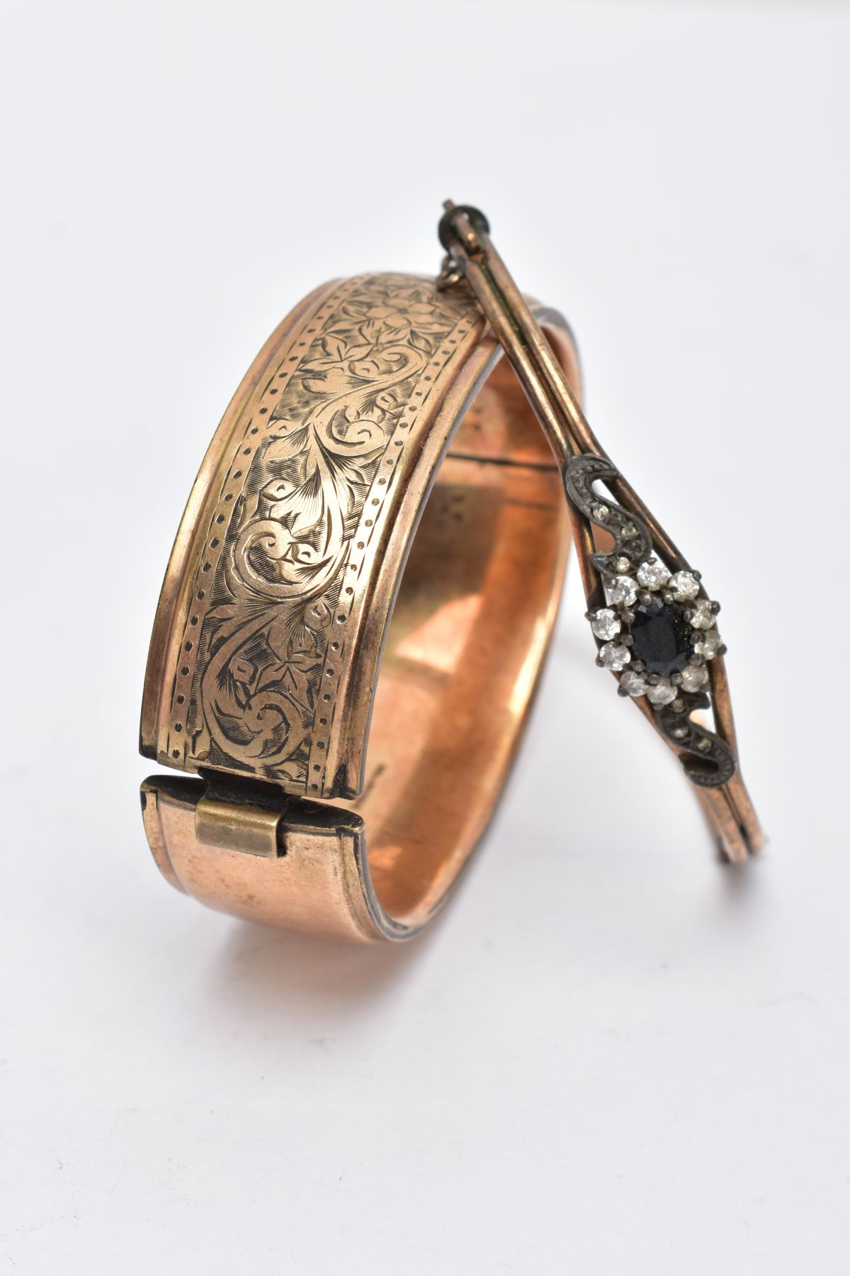 TWO ROLLED GOLD BANGLES, the first a wide bangle, decorated with an engraved floral design, fitted - Image 3 of 4