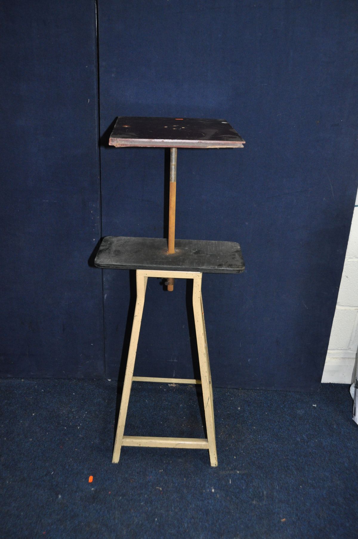 A MID 20TH CENTURY ARTIST MODELLING TABLE (possibly a converted stool) with shaped angle iron legs