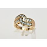 A 9CT GOLD AQUAMARINE DRESS RING, of a cross over style, set with two rows of circular cut