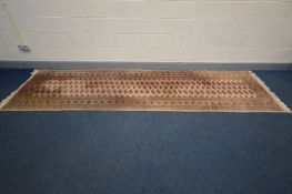 A WOOLEN TEKKE CARPET RUNNER, 374cm x 101cm (slightly discoloured) and a Chinese circular rug,