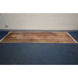 A WOOLEN TEKKE CARPET RUNNER, 374cm x 101cm (slightly discoloured) and a Chinese circular rug,