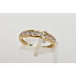A 9CT GOLD DIAMOND HALF ETERNITY RING, designed with a row of channel set, graduated round brilliant