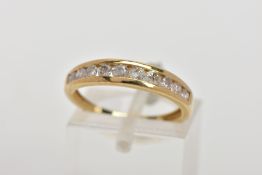 A 9CT GOLD DIAMOND HALF ETERNITY RING, designed with a row of channel set, graduated round brilliant