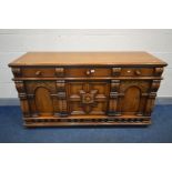 A REPRODUCTION SOLID OAK SIDEBOARD, with three drawers above two arched panelled doors flanking a