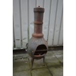 A LARGE CAST METAL CHIMINEA, height 130cm, with hoop handles and shaped legs