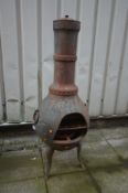 A LARGE CAST METAL CHIMINEA, height 130cm, with hoop handles and shaped legs