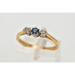 AN 18CT GOLD SAPPHIRE AND DIAMOND RING, designed with a central circular cut blue sapphire,