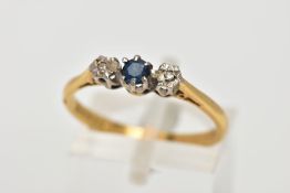 AN 18CT GOLD SAPPHIRE AND DIAMOND RING, designed with a central circular cut blue sapphire,