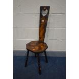 AN EARLY 20TH CENTURY STAINED WOOD POKERWORK SPINNING CHAIR