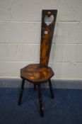 AN EARLY 20TH CENTURY STAINED WOOD POKERWORK SPINNING CHAIR