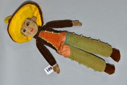 A NORAH WELLINGS CLOTH DOLL, pressed felt head, glass eyes, moulded and painted features, velvet