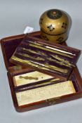 A VICTORIAN WALNUT CASED TECHNIAL DRAWING SET, the top tier lifts out to reveal a compartment