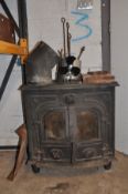 A CAST IRON LOG BURNER with two glazed doors, two water inlets and two outlets to rear, flues,