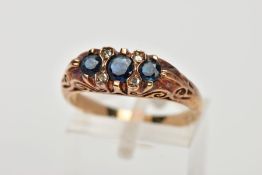 A 9CT GOLD SAPPHIRE AND DIAMOND RING, designed with three circular cut blue sapphires, interspaced