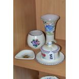 FOUR PIECES OF POOLE POTTERY, three of which are decorated with floral sprays, comprising a