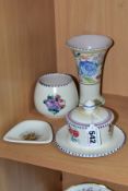 FOUR PIECES OF POOLE POTTERY, three of which are decorated with floral sprays, comprising a