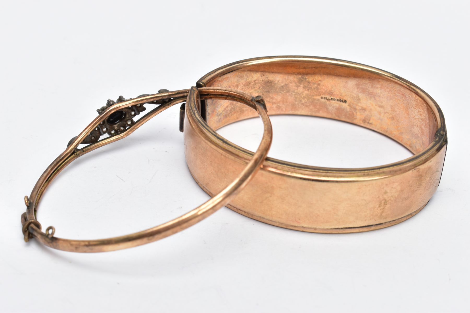 TWO ROLLED GOLD BANGLES, the first a wide bangle, decorated with an engraved floral design, fitted - Image 4 of 4