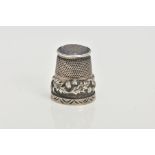 A SILVER THIMBLE, decorated with thistles and set with a possibly chalcedony terminal, hallmarked '