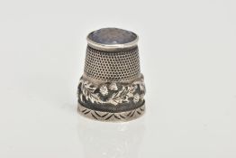 A SILVER THIMBLE, decorated with thistles and set with a possibly chalcedony terminal, hallmarked '