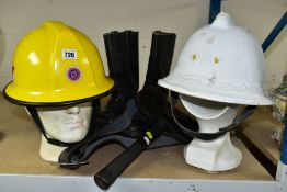 FIRE SERVICE INTEREST - TWO HELMETS, BOOTS AND AXE, the axe head in a sturdy leather pouch