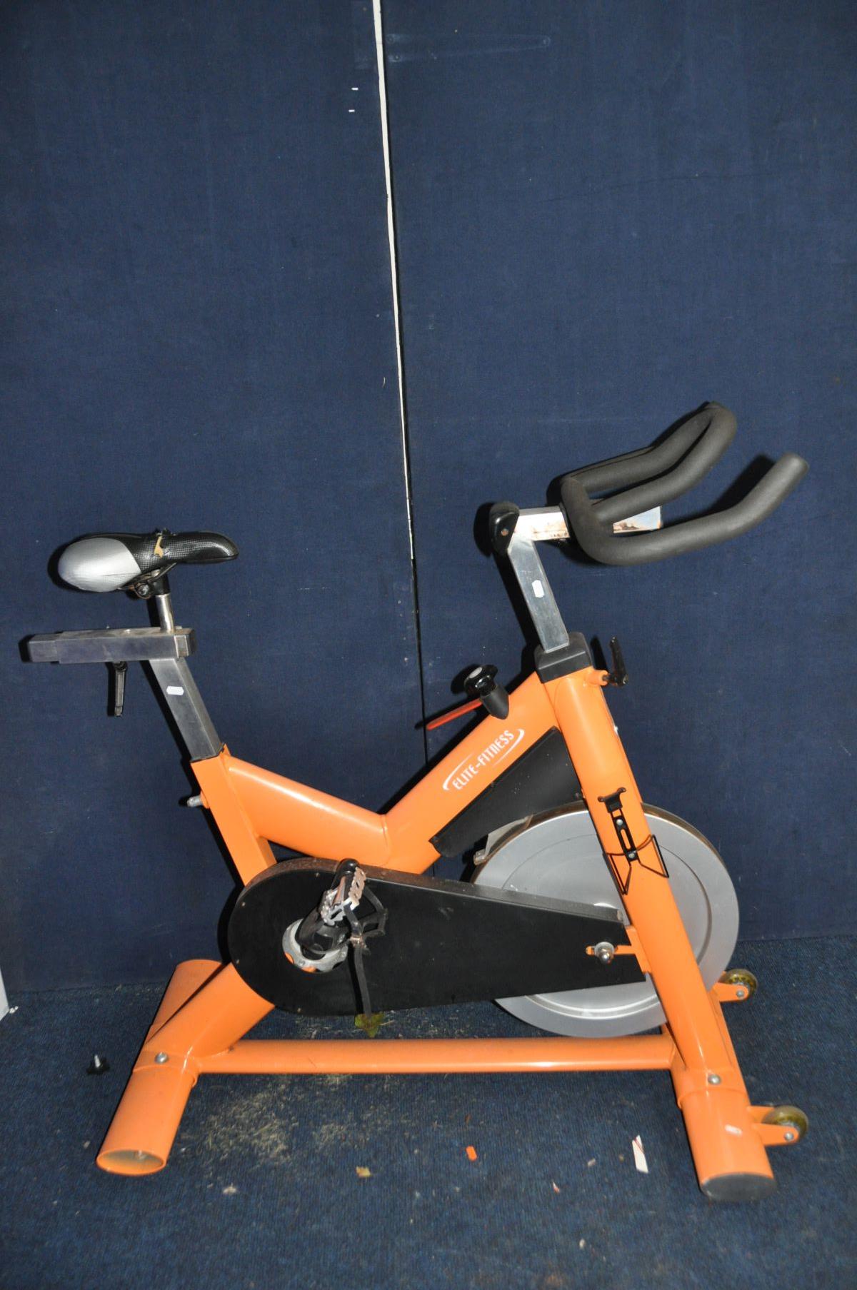 AN ELITE-FITNESS SPIN BIKE (one end cap on base missing)