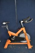 AN ELITE-FITNESS SPIN BIKE (one end cap on base missing)