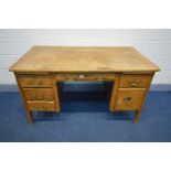 A 20TH CENTURY OAK DESK, with six drawers, width 137cm x depth 76cm x height 76cm (condition - loose