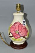 A MOORCROFT PINK MAGNOLIA PATTERN TABLE LAMP of baluster form with tube lined pattern on a cream