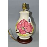 A MOORCROFT PINK MAGNOLIA PATTERN TABLE LAMP of baluster form with tube lined pattern on a cream