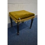 A LATE VICTORIAN EBONISED STOOL with green upholstery