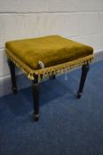 A LATE VICTORIAN EBONISED STOOL with green upholstery