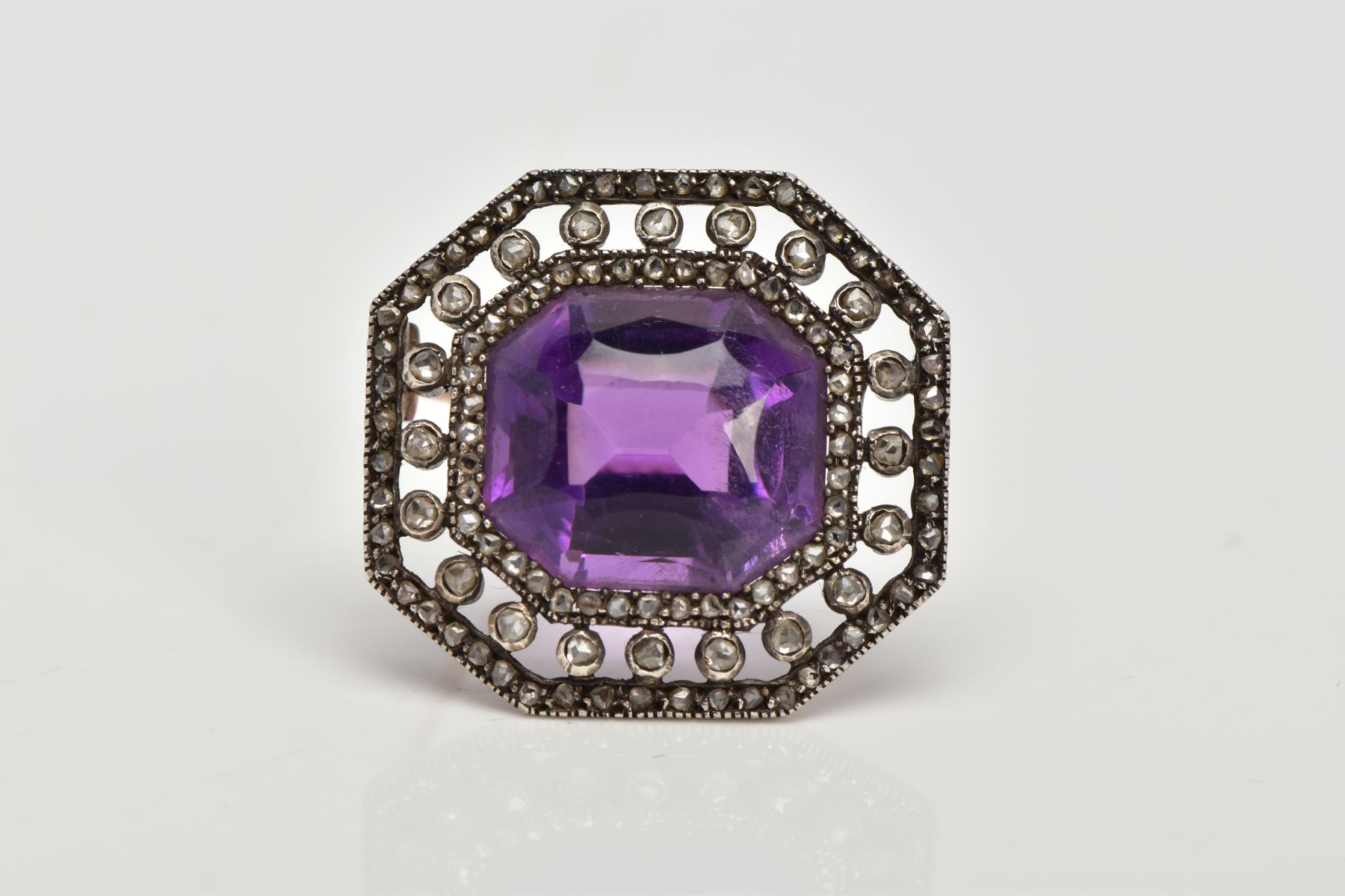 A LATE VICTORIAN AMETHYST AND ROSE CUT DIAMOND BROOCH, centring on a cushion cut amethyst, within an