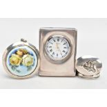 A SILVER ENAMEL COMPACT, A SILVER BEDSIDE CLOCK AND A SILVER PILL BOX, the compact of a circular