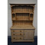 A VICTORIAN PINE DRESSER, with a later top, the base with three drawers besides a cupboard doors,