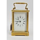 A BRASS CARRIAGE CLOCK, white dial, Roman numerals, blue hands, within a five glass panel