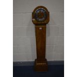 AN ART DECO WALNUT CASED GRAND DAUGHTER CLOCK, with a silvered dial and roman numerals, height 140cm