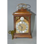 A GEORGE VI CHARLES FRODSHAM WALNUT AND GILT BRASS MOUNTED MINIATURE BRACKET CLOCK, the arched brass