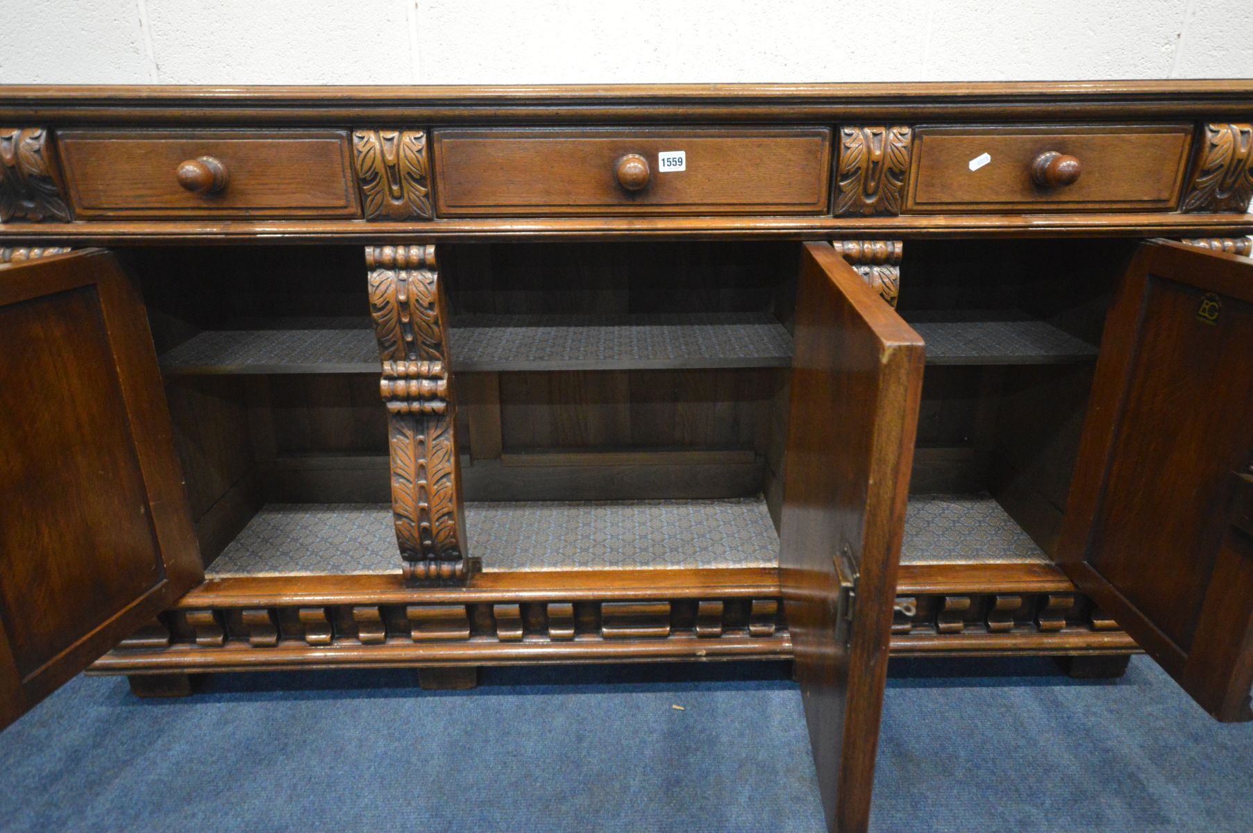 A REPRODUCTION SOLID OAK SIDEBOARD, with three drawers above two arched panelled doors flanking a - Image 3 of 4