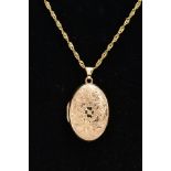 A 9CT GOLD LOCKET NECKLACE, the locket of an oval form, embossed floral design to the front, opens