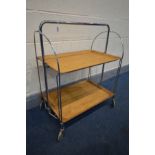 A MID 20TH CENTURY FOLDING CHROME AND WOODEN TEA TROLLEY, by Gerlinol Brenshey Dinett, width 67cm