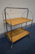 A MID 20TH CENTURY FOLDING CHROME AND WOODEN TEA TROLLEY, by Gerlinol Brenshey Dinett, width 67cm