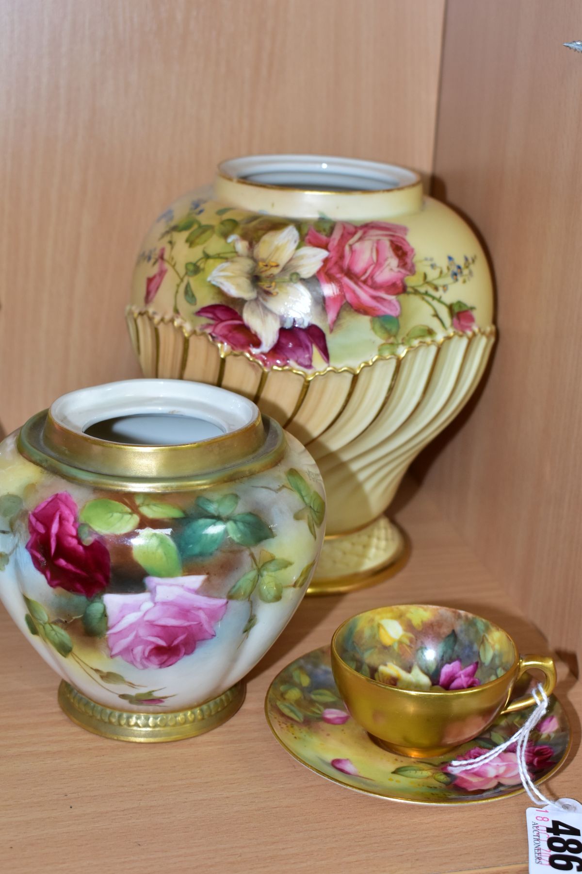 A ROYAL WORCESTER CABINET CUP AND SAUCER AND TWO ROYAL WORCESTER POT POURRIS LACKING COVERS, the cup