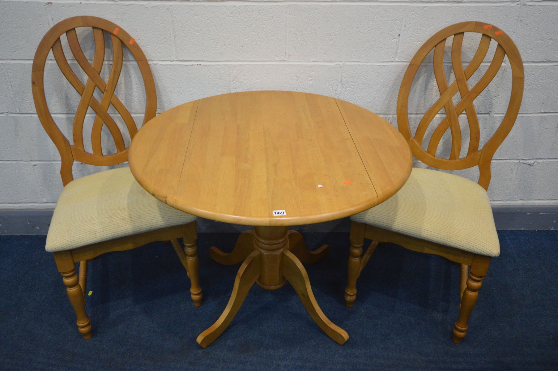 A BEECH DROP LEAF KITCHEN PEDESTAL TABLE, open diameter 92cm x height 73cm and two chairs (3)