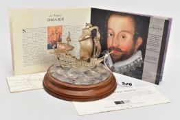 A ROYAL MINT SILVER MODEL OF THE 'GOLDEN HIND', mounted atop of a wavey sea detailed base signed '
