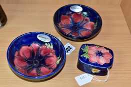 A PAIR OF MOORCROFT POTTERY SHALLOW FOOTED BOWLS AND A SMALL TRINKET BOX AND COVER, all decorated