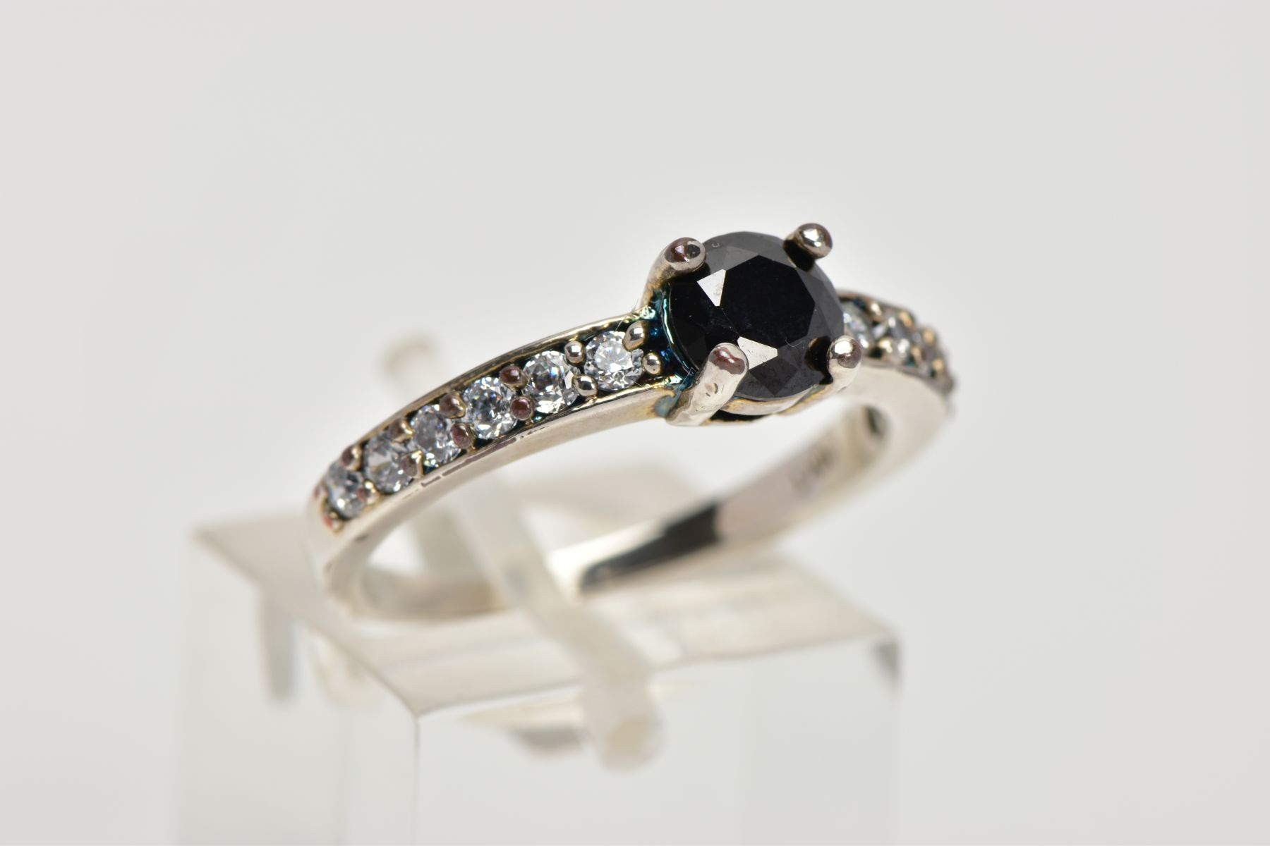 A WHITE METAL CUBIC ZIRCONIA DRESS RING, designed with a central circular cut black stone assessed - Image 4 of 4