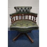 A GREEN BUTTONED LEATHER SWIVEL OFFICE CHAIR (condition - leather cracking, two loose casters)