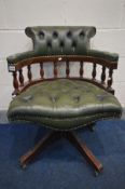 A GREEN BUTTONED LEATHER SWIVEL OFFICE CHAIR (condition - leather cracking, two loose casters)